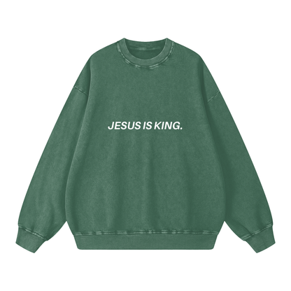 Green sweatshirt with 'JESUS IS KING.' text on a white background